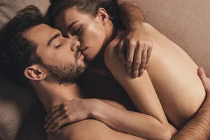 Nude couple cuddling with each other